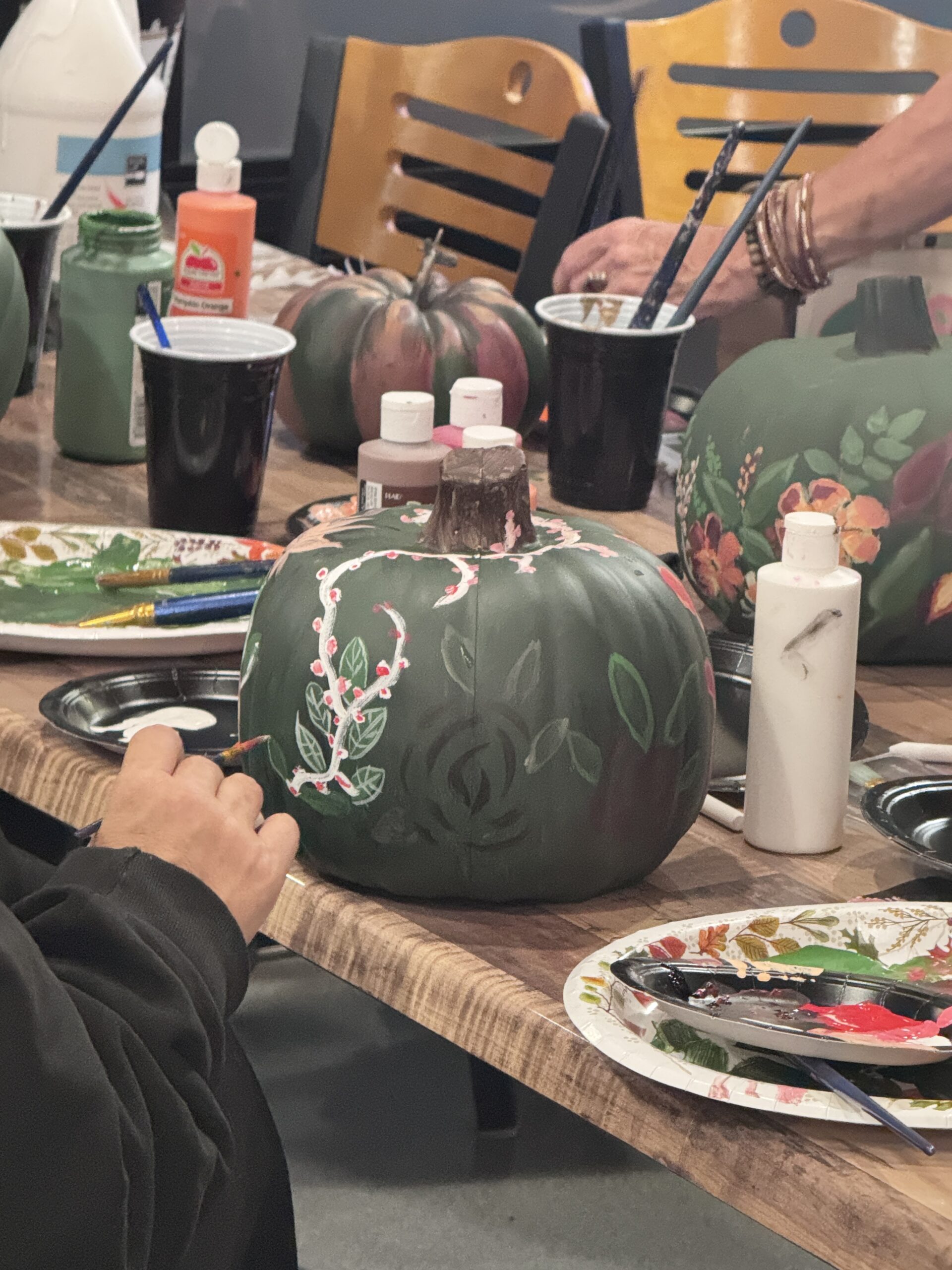 Hand-painted pumpkins in progress at the Fall Boho Paint Series